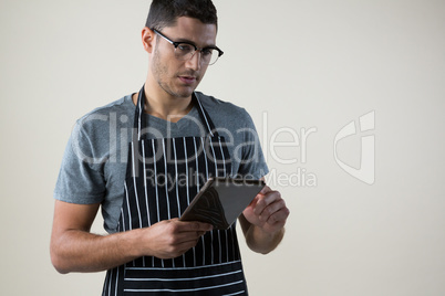 Waiter looking at the digital tablet