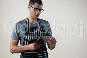 Waiter looking at the digital tablet