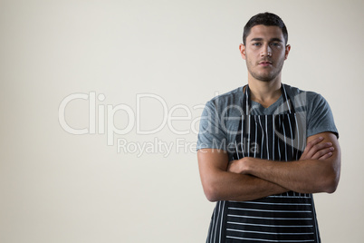 Confident waiter standing with his hands crossed Confident waiter standing with his hands crossed
