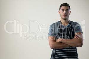 Confident waiter standing with his hands crossed