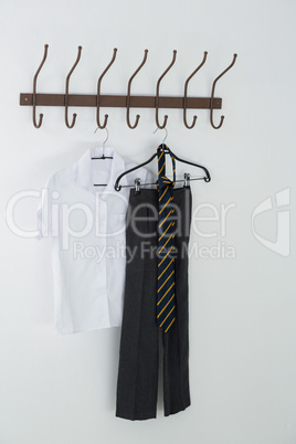 Formal shirt, tie and pants hanging on hook