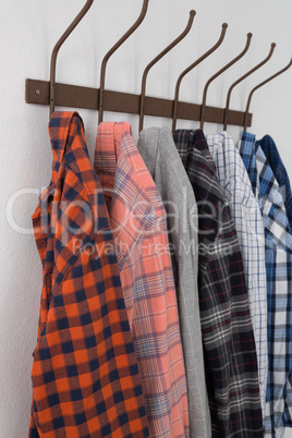 Close-up of various shirts hanging on hook