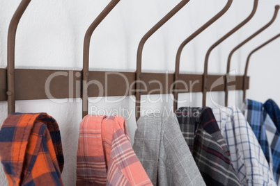 Close-up of various shirts hanging on hook