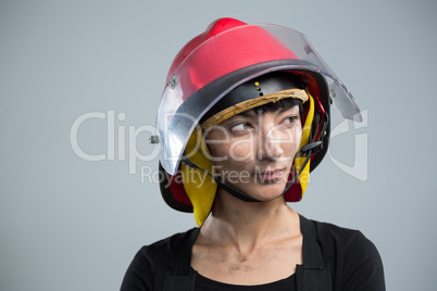 Female architect wearing helmet against white background