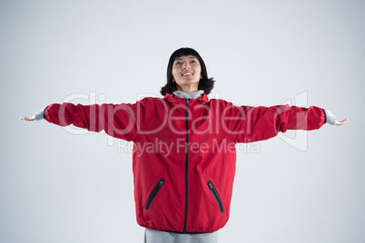 Smiling woman standing with arms outstretched Smiling woman standing with arms outstretched