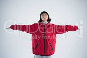 Smiling woman standing with arms outstretched