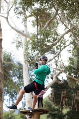 Man enjoying zip line adventure in park