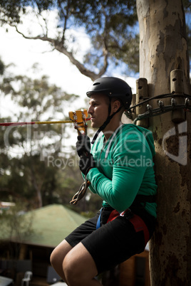 Man ready to zip line in adventure park