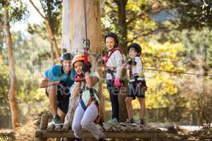 Kids enjoying zip line adventure on sunny day