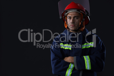 Confident fireman standing with his hands crossed