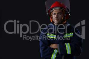 Confident fireman standing with his hands crossed