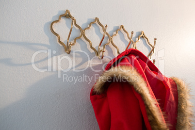 Close-up of red hoodie hanging on hook