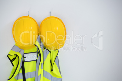 Close-up of protective workwear hanging on hook