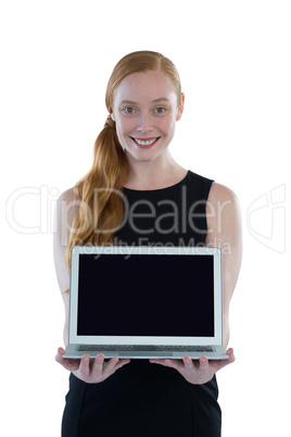 Female executive holding laptop