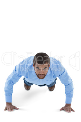 Male executive performing push ups