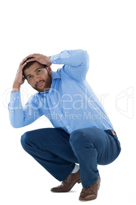 Male executive sitting against white background