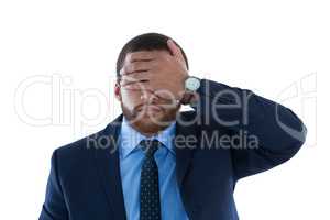 Businessman covering his eyes