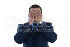 Businessman covering his eyes