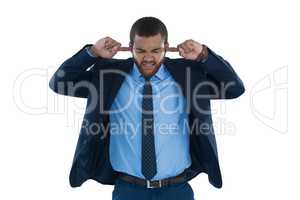 Irritated businessman covering his ears
