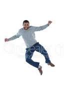 Male executive jumping against white background