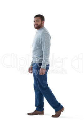 Male executive walking against white background