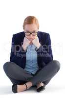 Businesswoman sitting against white background