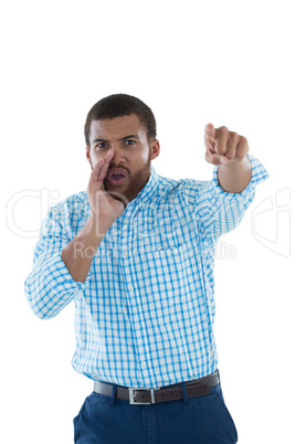 Male executive shouting against white background