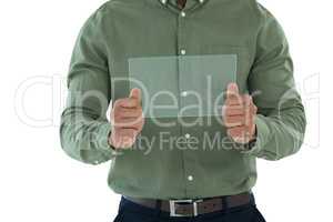 Male executive using glass digital tablet