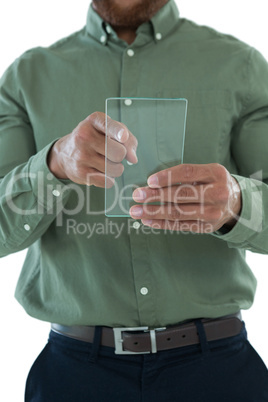 Male executive using glass digital tablet