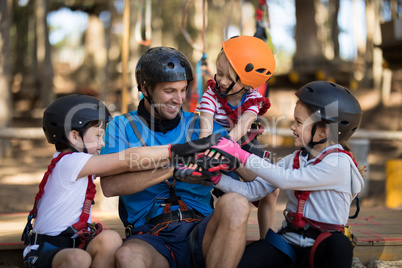 Instructor and kids forming hand stack in park