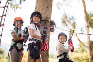 Kids enjoying zip line adventure on sunny day