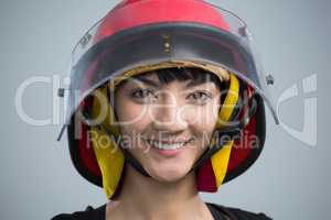 Smiling female architect standing against white background