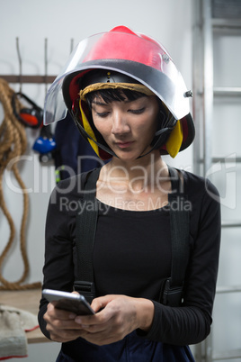 Female architect using mobile phone