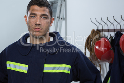 Tiered fireman standing in the office