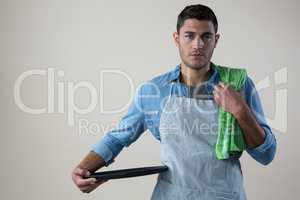 Waiter standing with a tray and napkin