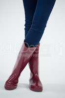 Woman in wellington boot standing with leg crossed