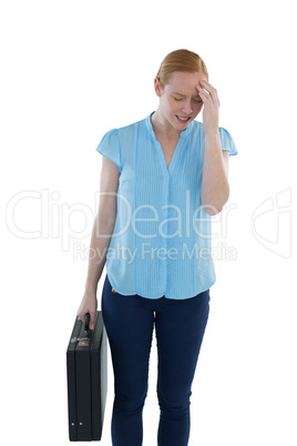 Upset female executive standing with briefcase