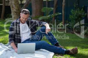 Man using laptop in garden