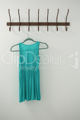 Turquoise dress hanging on hook