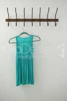 Turquoise dress hanging on hook