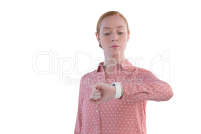 Female executive looking at wristwatch