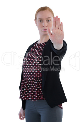 Female executive making stop sign against white background