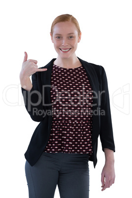 Female executive gesturing against white background