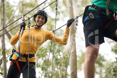 Woman enjoying zip line adventure in park