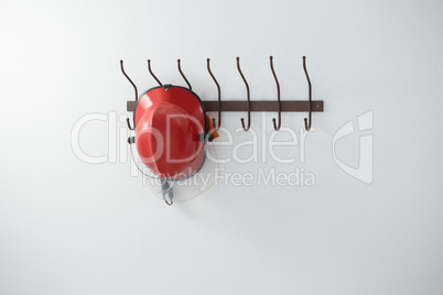 Red hardhat hanging on hook