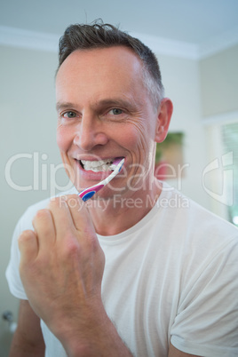 Man brushing his teeth with toothbrush