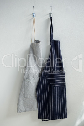 Aprons hanging on hook