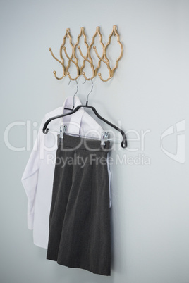 Formal shirt and skirt hanging on hook