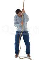 Male executive pulling the rope against white background
