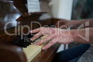 Man playing piano at home